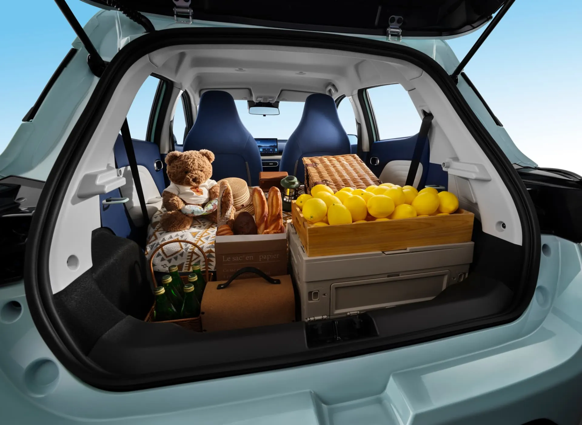 JMEV EV3 open trunk packed with picnic baskets, boxes and luggage