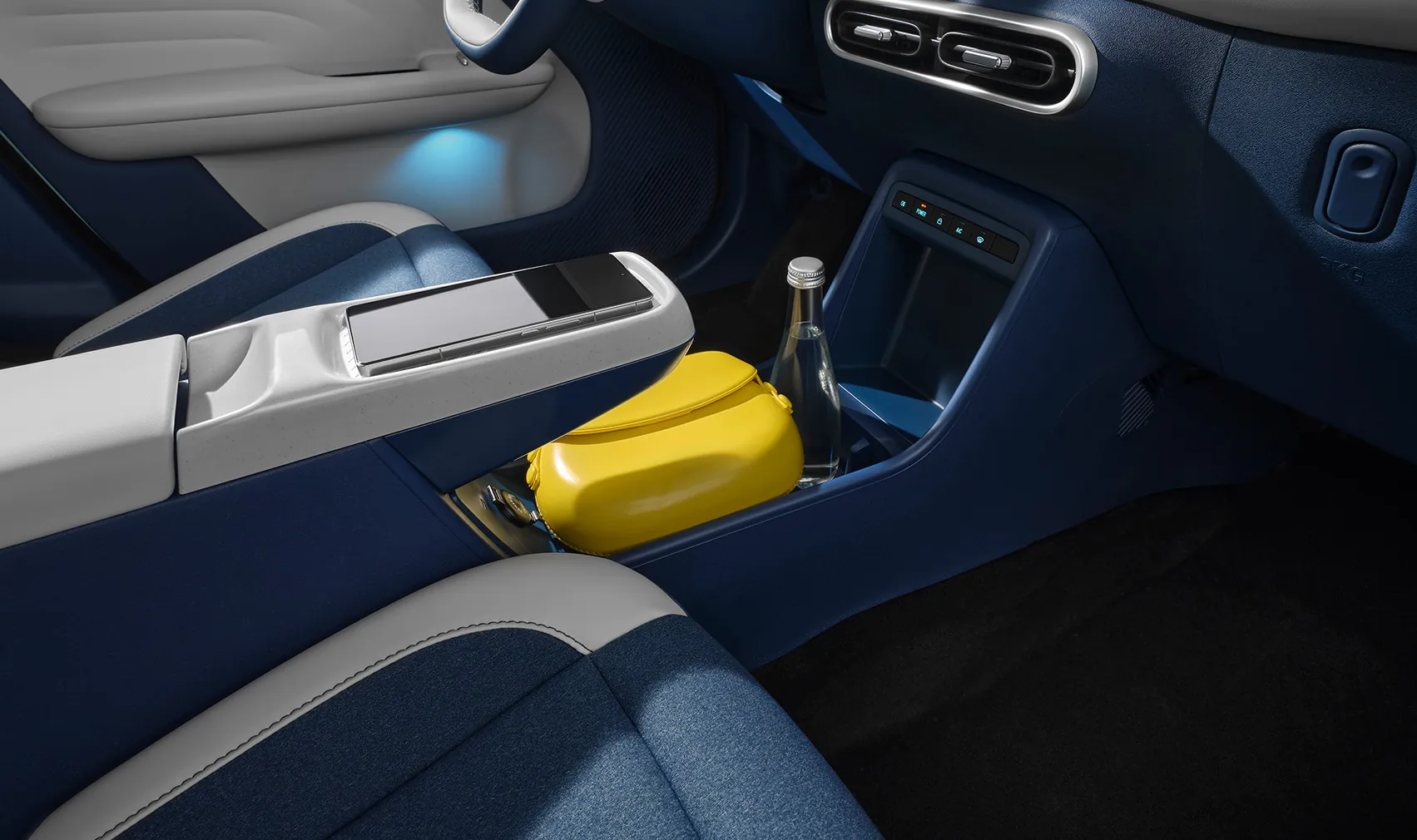 Smartphone resting on the JMEV EV3 wireless charging pad